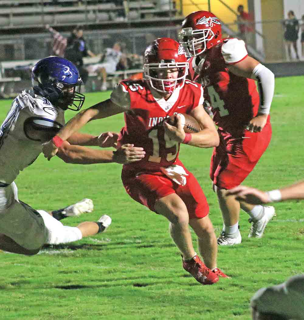 Groveton quarterback Tanner Steubing (No. 15) cuts through the defense for first points of the night. Photo by Tony Farkas