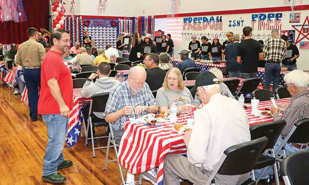 Veterans enjoy a meal prepared by Groveton ISD to honor them for their service. Photo by Chris Edwards