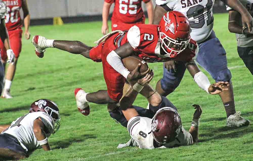 Groveton’s Bryon Thomas (No. 2) gets tripped up for a gain. Photo by Tony Farkas