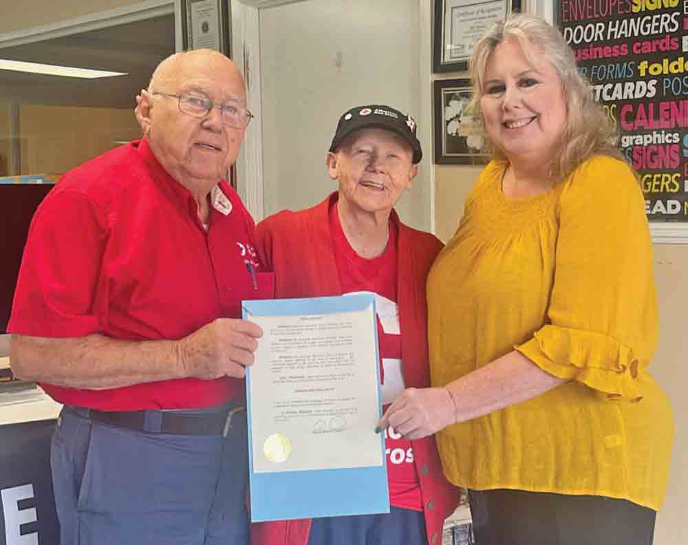 Red Cross recognized – John  and Mary Annette Stagg, two longtime volunteers with the American Red Cross, accept a proclamation recognizing Red Cross month in Woodville from Woodville Mayor Amy Bythewood. MOLLIE LA SALLE | TCB