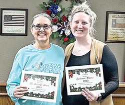 Kathy Lott accepts the first-place certificate on behalf of Extreme Fitness and the third-place certificate on behalf of Greater Onalaska Heritage Society from Macey George for the annual Christmas decorating contest. George White & Sons Body Shop placed second. Courtesy photo