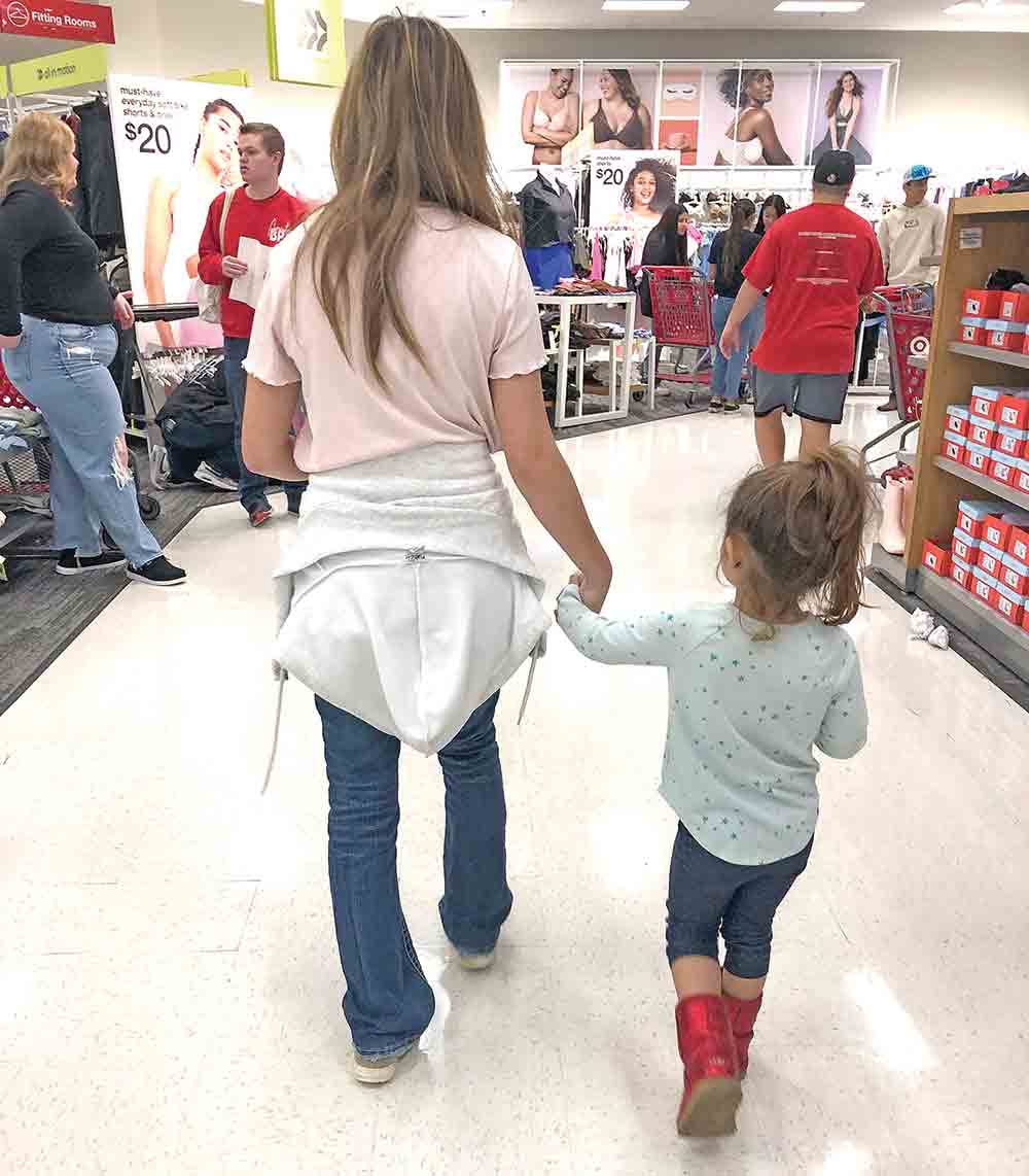 A Groveton FCCLA member walks with an elementary school student after the two bought new shoes for the child as part of the Kicks for Kids events. Courtesy photos