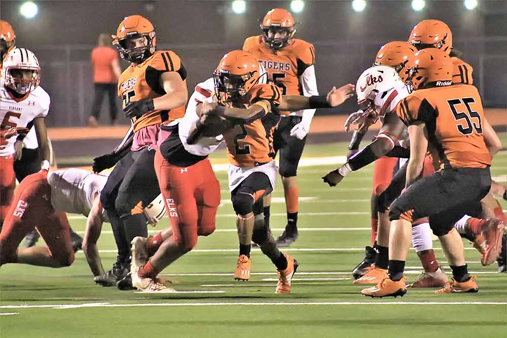 Trinity’s Juju Clayborne (No. 2) picks up some yards during the Tigers’ Homecoming game on Friday. The Tigers were edged out 29-28 on the night. Photo by Tony Farkas.
