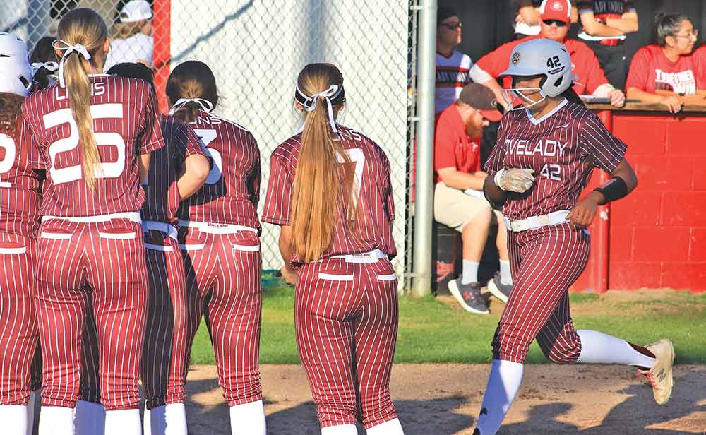 Lovelady's Mihyia Davis is greeted by her teammates after hitting a leadoff homer against Groveton in a district contest last Tuesday. 
