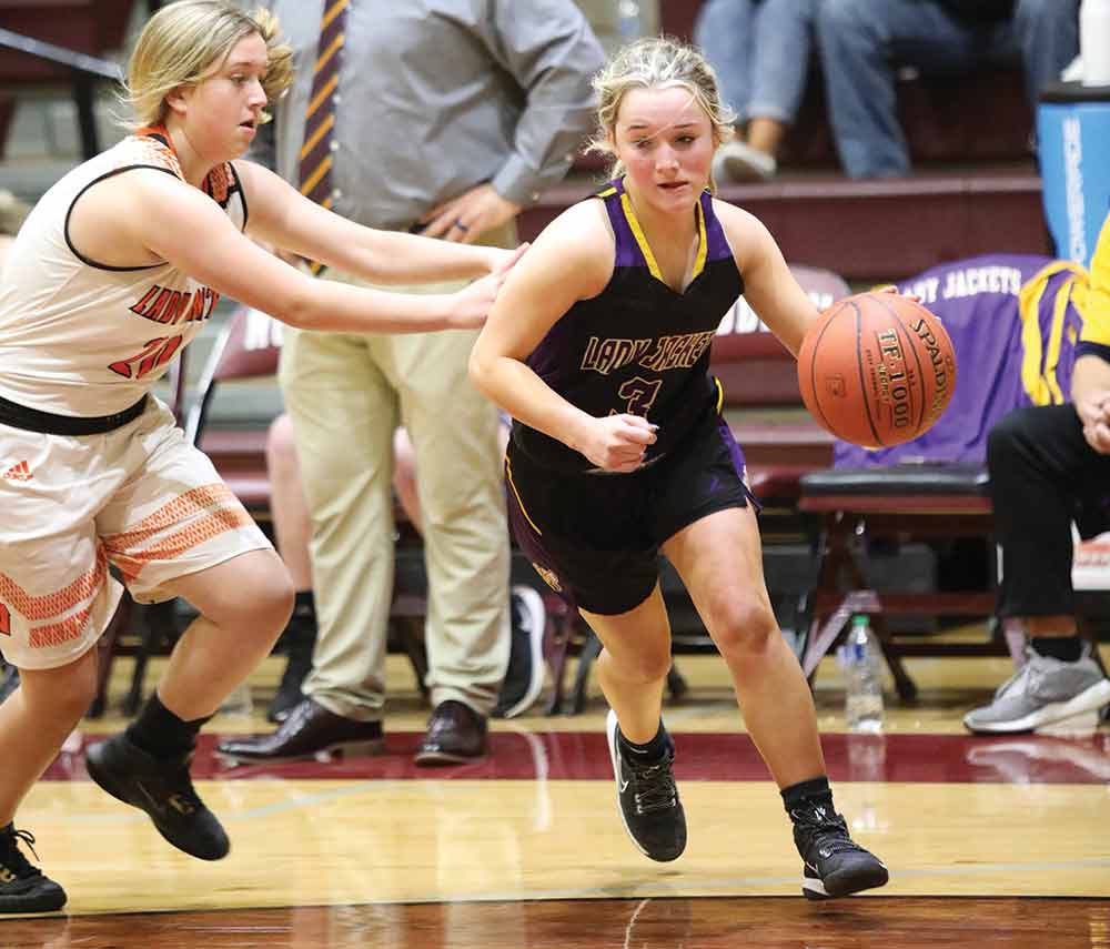 Lady Jacket Kat Knox dribbles around a Lady Pirate defender in their bi-district loss to Wells on Monday.  JANA RAYBURN | TCB 