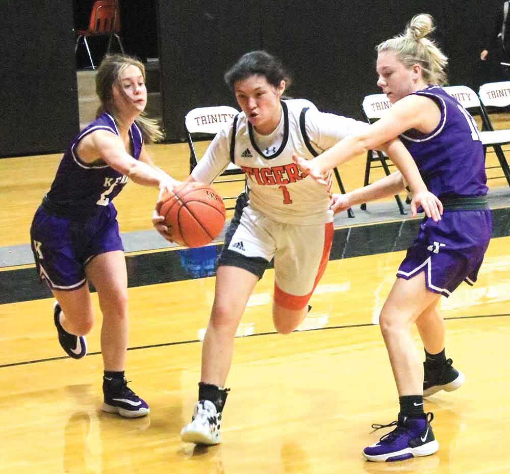 Lady Tiger Dayanara Martinez (No. 1) cuts through two Kennard defenders during a Friday game in Trinity. The Lady Tigers won the match  74-29.