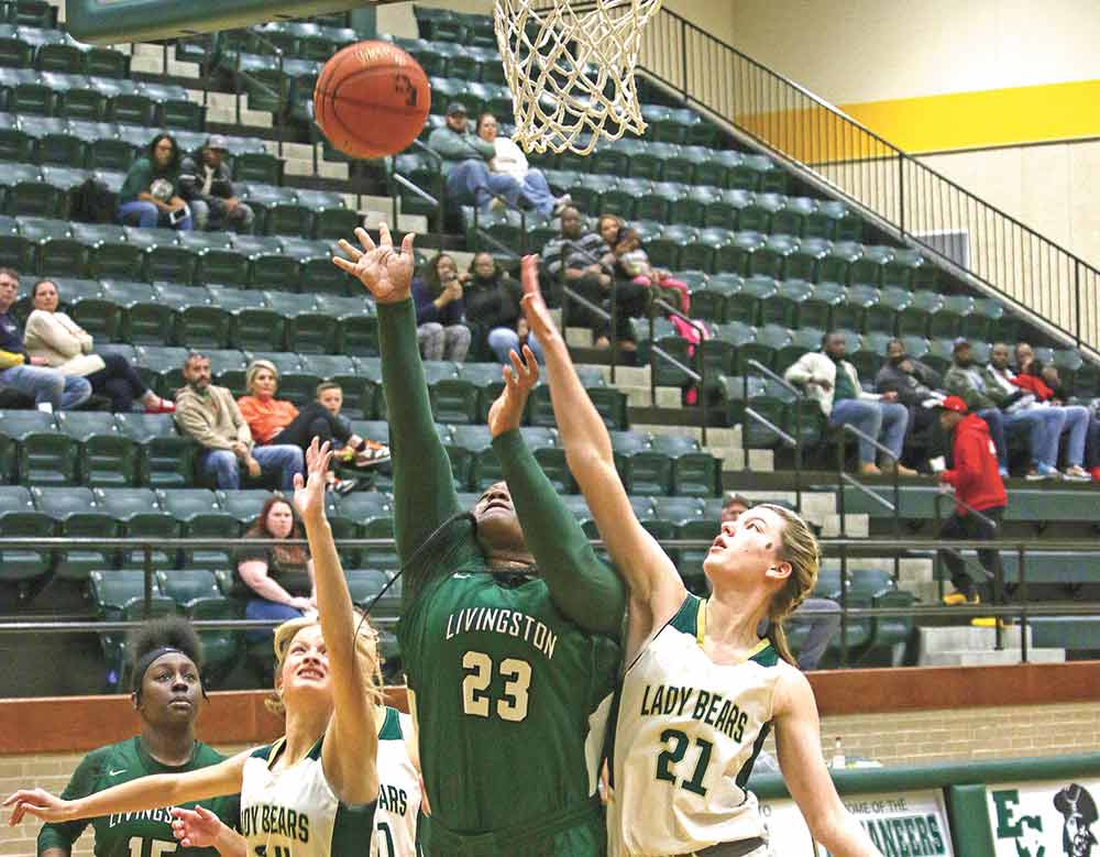 Jon’Toyrian McNeal puts up a shot between two defenders. Photos by Brian Besch
