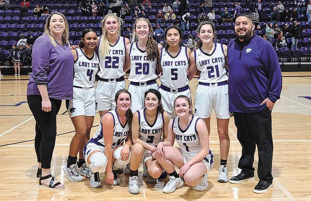 The team stops for a group shot after the game. The 2021-22 Big Sandy Lady Cats include (standing, left to right) Samantha White, Briana Miles, Lauren Hulin, Kalyssa Dickens, Savanna Poncho, Corynn Kaleh, Ryan Alec, (kneeling, left to right) Faith Geller, Alexis Thompson and Kamryn Mayer. Photos by Brian Besch