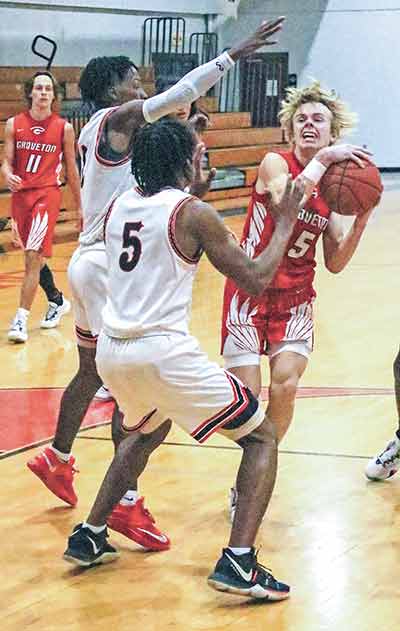 A Groveton player gets into traffic during the Indians’ 86-22 loss to the Trojans.